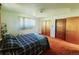 Sunny bedroom with a blue comforter and an expansive closet for storage and style at 15065 Huron St, Broomfield, CO 80023