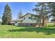 Rear exterior view highlighting the home's architecture and spacious backyard at 15065 Huron St, Broomfield, CO 80023