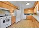 Bright kitchen featuring white appliances, wood cabinets and unique tile flooring at 15065 Huron St, Broomfield, CO 80023