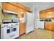 Well-lit kitchen featuring white appliances and lots of storage with wood cabinets at 15065 Huron St, Broomfield, CO 80023