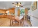 Eat-in kitchen with wooden cabinetry, warm lighting, and a view of the outdoors at 15065 Huron St, Broomfield, CO 80023