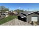 Aerial backyard view of a well-maintained yard, a shop building, and mature trees at 504 Elizabeth Ave, Platteville, CO 80651