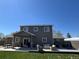 Spacious backyard with a covered patio, hot tub, comfortable seating, and lush green lawn at 504 Elizabeth Ave, Platteville, CO 80651
