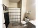 Full bathroom with shower, toilet, and vanity with gray cabinets at 504 Elizabeth Ave, Platteville, CO 80651