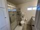 Bathroom featuring glass shower door, vanity with granite countertop and toilet at 504 Elizabeth Ave, Platteville, CO 80651