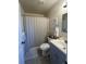 Full bathroom features a shower with a curtain, a sink, and decor at 504 Elizabeth Ave, Platteville, CO 80651