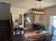 Charming dining area with modern lighting fixture adjacent to the kitchen and living areas at 504 Elizabeth Ave, Platteville, CO 80651