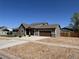 Charming single-Gathering home featuring a well-manicured lawn, concrete driveway, and backyard shop building at 504 Elizabeth Ave, Platteville, CO 80651