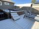 Backyard deck featuring a hot tub with privacy fencing and comfortable lounge chairs at 504 Elizabeth Ave, Platteville, CO 80651