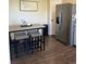 Cozy kitchen nook with a table, stools, and stainless steel refrigerator at 504 Elizabeth Ave, Platteville, CO 80651