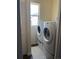 Convenient laundry area with stacked washer and dryer units near the window at 504 Elizabeth Ave, Platteville, CO 80651