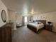 Spacious primary bedroom featuring a large bed, dresser, and natural light at 504 Elizabeth Ave, Platteville, CO 80651