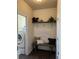 Functional mud room with bench, shelving, and a decorative wall hanging at 504 Elizabeth Ave, Platteville, CO 80651
