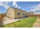 Charming backyard featuring a concrete patio, grassy area, and landscaped space, ideal for outdoor gatherings at 16076 Columbine Pl, Thornton, CO 80602