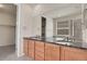 Bathroom featuring dual sinks, granite counters, large mirror, and tile flooring at 16076 Columbine Pl, Thornton, CO 80602