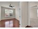 Bright bedroom featuring hardwood floors, a ceiling fan, and natural light at 16076 Columbine Pl, Thornton, CO 80602