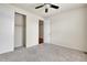 Bedroom featuring neutral carpet, a ceiling fan, closet, and ensuite bathroom at 16076 Columbine Pl, Thornton, CO 80602