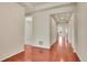 Bright hallway with gleaming hardwood floors leading to other rooms at 16076 Columbine Pl, Thornton, CO 80602