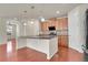 Open kitchen with a large island, pendant lighting, and stainless steel appliances at 16076 Columbine Pl, Thornton, CO 80602