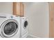 Convenient laundry room featuring a washer, dryer, and storage cabinets for effortless organization at 16076 Columbine Pl, Thornton, CO 80602