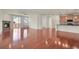 Open floor plan with a modern kitchen and a living area with a fireplace at 16076 Columbine Pl, Thornton, CO 80602