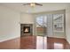 Cozy living room with a fireplace, sliding glass doors, and ample natural light at 16076 Columbine Pl, Thornton, CO 80602