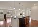 Open layout featuring a modern kitchen flowing into a bright living area with a fireplace at 16076 Columbine Pl, Thornton, CO 80602