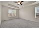 Spacious main bedroom with tray ceiling, ceiling fan, neutral carpet and great natural light at 16076 Columbine Pl, Thornton, CO 80602