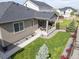Aerial view of a home with a covered patio and a well-manicured backyard in a suburban neighborhood at 21893 E Tufts Cir, Aurora, CO 80015