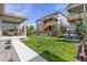 Charming backyard with a covered patio, beautiful lawn, and well-maintained landscaping at 21893 E Tufts Cir, Aurora, CO 80015