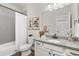 Modern bathroom with granite countertops, white cabinets, and framed flower art at 21893 E Tufts Cir, Aurora, CO 80015