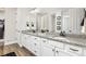 Well-lit bathroom featuring dual sinks, granite counters, and a large mirror at 21893 E Tufts Cir, Aurora, CO 80015