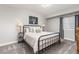 Tranquil bedroom with a black metal bed frame, neutral walls and lots of light at 21893 E Tufts Cir, Aurora, CO 80015