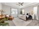 Spacious bedroom with tray ceiling, ceiling fan, sitting area, and plenty of natural light at 21893 E Tufts Cir, Aurora, CO 80015