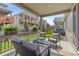 Relaxing covered patio with a cozy seating area, overlooking the landscaped backyard at 21893 E Tufts Cir, Aurora, CO 80015
