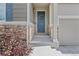 Welcoming front entrance with stone accents, a classic door, and a well-maintained walkway at 21893 E Tufts Cir, Aurora, CO 80015