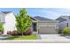 Attractive single-Gathering home with a two-car garage, stone details, and manicured front lawn at 21893 E Tufts Cir, Aurora, CO 80015