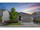 Charming single-Gathering home featuring a two-car garage, stone accents, and a beautifully landscaped front yard at 21893 E Tufts Cir, Aurora, CO 80015