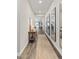 Bright hallway with wood flooring, modern mirrors, and elegant decor at 21893 E Tufts Cir, Aurora, CO 80015