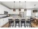 Stylish kitchen with white cabinetry, granite countertops, stainless steel appliances, and a center island with seating at 21893 E Tufts Cir, Aurora, CO 80015
