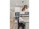 Kitchen features a stone counter, stainless steel appliances, pendant lighting, and breakfast bar seating at 21893 E Tufts Cir, Aurora, CO 80015