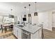 Open kitchen area with island seating, stainless appliances, granite countertop and natural light at 21893 E Tufts Cir, Aurora, CO 80015