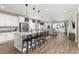 Open-concept kitchen with stainless steel appliances, granite counters, pendant lighting, and breakfast bar at 21893 E Tufts Cir, Aurora, CO 80015