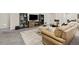 Cozy living room with large TV, comfortable seating, and stylish decor on gray carpet at 21893 E Tufts Cir, Aurora, CO 80015