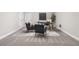 Finished basement featuring gray chairs, desk area, neutral walls and carpet at 21893 E Tufts Cir, Aurora, CO 80015
