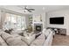 Cozy living room with fireplace, ceiling fan, plush seating, and sliding glass door to backyard at 21893 E Tufts Cir, Aurora, CO 80015