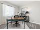 Comfortable home office with natural light, a wooden desk, and stylish decor at 21893 E Tufts Cir, Aurora, CO 80015