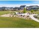 Community playground area with a covered picnic area, slide, and greenery at 21893 E Tufts Cir, Aurora, CO 80015