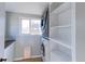 Bright laundry room, washer, dryer, and built-in shelving at 304 Mckinley Ave, Fort Lupton, CO 80621