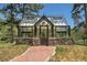 Spacious greenhouse with stonework and glass windows at 322 Greystone Rd, Evergreen, CO 80439